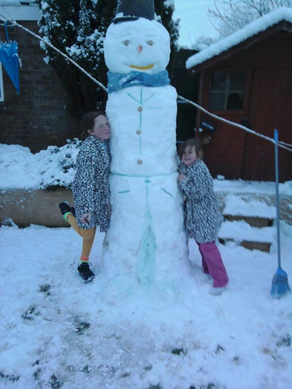 Slushy: youngsters give their snowman a hug