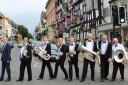 Members of Ledbury Brass Band parody the iconic album cover by the Beatles