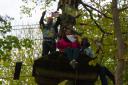 Members of Mecca Catford playing extreme bingo 60 feet up a tree