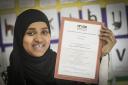 Ramla Farah, of A Class Tutors, holds the group's bronze award from the NRCSE