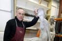 Conservator Steve Mellor with the statue