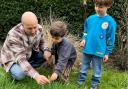 Dominic Rose in his garden with sons Dexter and Theo (right) is bidding to open a community wildlife garden and bring all the Suburb's gardeners together