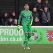 Elliot Justham saved a penalty but was beaten in stoppage time