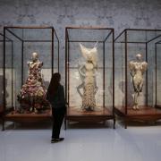 Dresses on display during the Alexander McQueen: Savage Beauty exhibition at the Victoria and Albert Museum in London