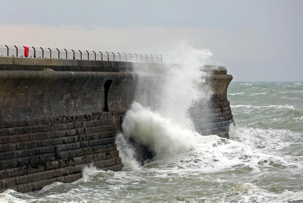 Waves crash against the harbour wall in Dover, Kent, as stormy weather sweeps across the country. Photo: PA