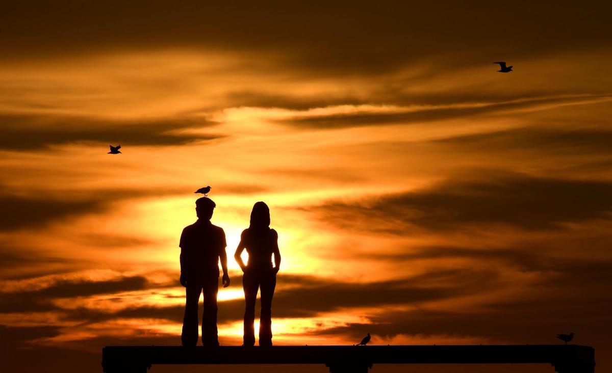 Sunrise over the north sea as The Couple by artist Sean Henery sits just off the coast at Newbiggin-by-the-Sea, Northumberland. Photo by Owen Humphreys/PA