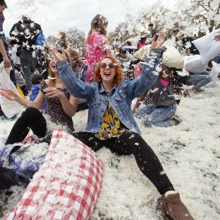 People take part in a mass pillow fight in Kennington Park in London to mark International Pillow Fight Day