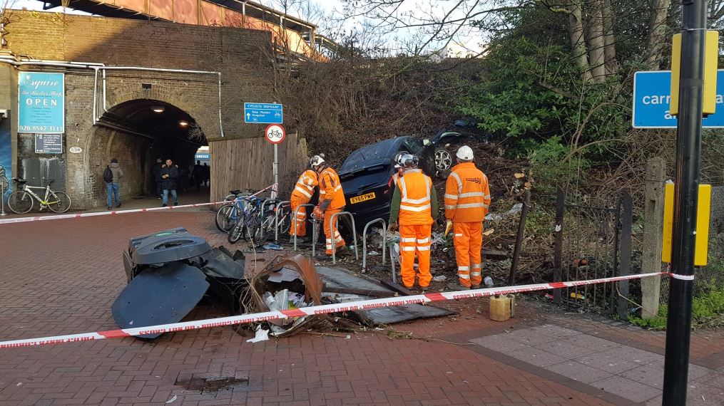 IN PICTURES: Driver ploughs through bollards then abandons crashed car at Raynes Park Station