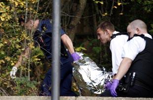 Police remove Asbo's body after the shooting