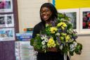 Member of staff at SHINE Merton with donated flowers