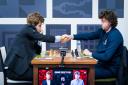 Magnus Carlsen and Hans Niemann shaking hands before the game