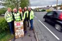 Residents with a homemade road sign on Whalley road, Langho