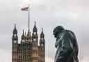 Winston Churchill looks on, outside the Houses of Parliament