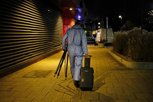 This Is Local London: A forensic officer near the scene in Mayes Road, Wood Green. Credit: PA