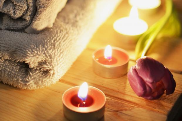 This Is Local London: A pile of towels, candles and a tulip. Credit: Canva