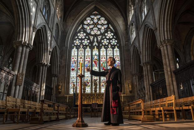 This Is Local London: Very Reverend John Dobson Dean of Ripon lights a candle to mark the second anniversary of the first national coronavirus lockdown at Ripon Cathedral, North Yorkshire, ahead of the National Day of Reflection on Wednesday (PA)