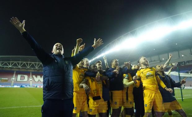 This Is Local London: Sutton United manager Matt Gray celebrates with his players after winning the penalty shoot -out during the Papa John's Trophy semi final match at the DW Stadium, Wigan
