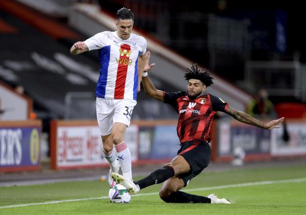 This Is Local London: Crystal Palace's Martin Kelly (left) is tackled by Bournemouth's Philip Billing during the Carabao Cup match at the Vitality Stadium, Bournemouth