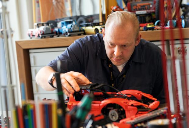 This is local London: a man assembling a LEGO Technic Ferrari Daytona SP3.  Credit: LEGO