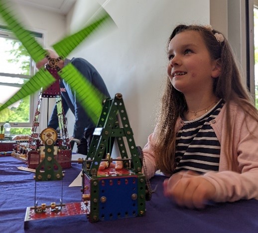 A visitor plays with Meccano