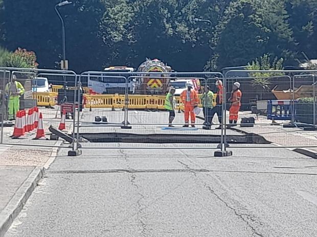 This Is Local London: Police tape and mental fencing blocked the public off from the 5m wide sinkhole that opened up on Martens Avenue (photo: Kiro Evans)