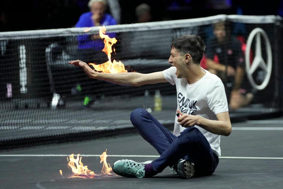 Protester sets his arm on fire during Laver Cup match in London