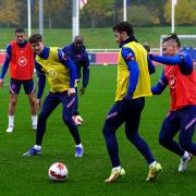 England's Ben Chilwell on the ball with Kalvin Phillips (second right) and John Stones during a training session at St George's Park. Credit: PA