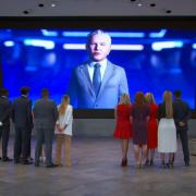 Candidates watching Lord Sugar during the pitch in a video game (BBC/Naked)