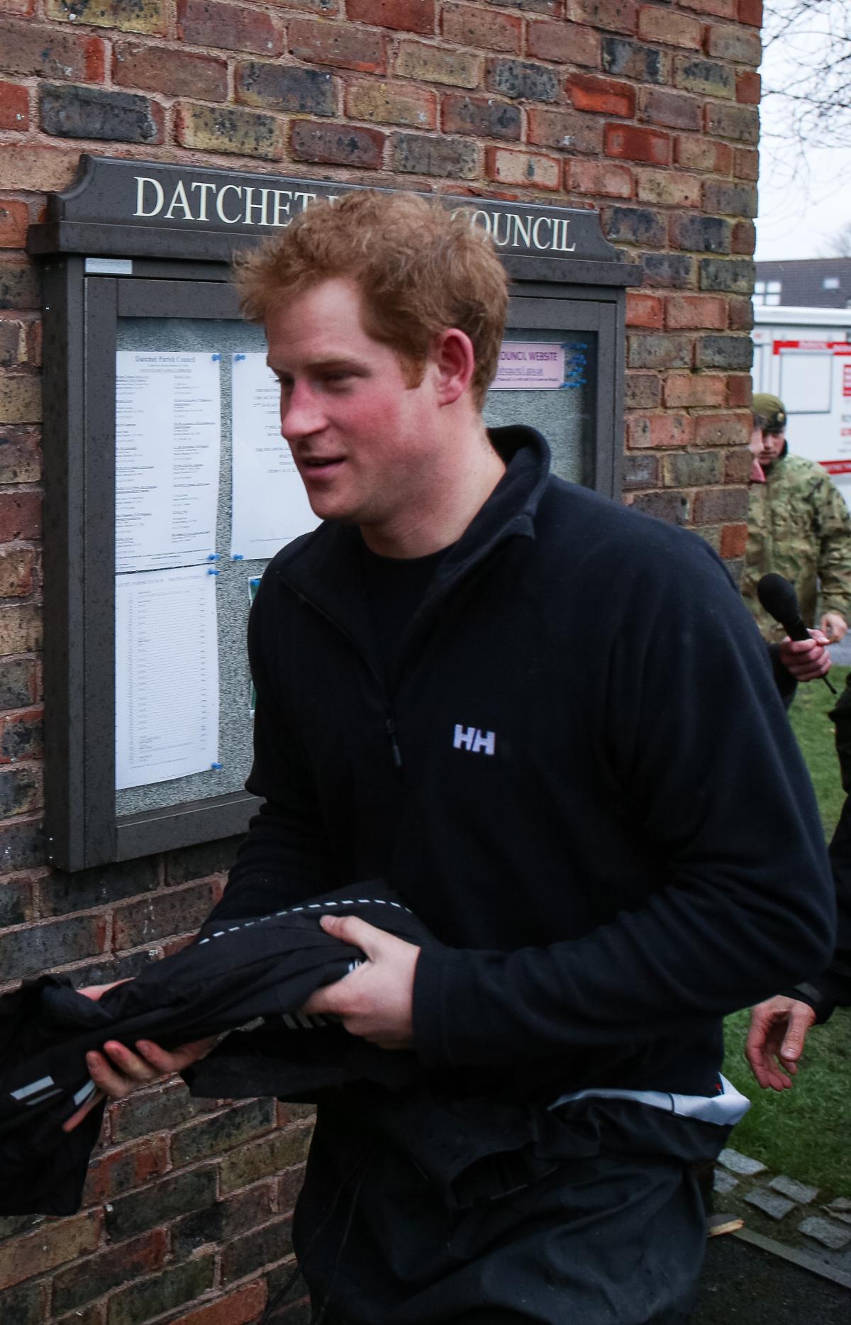 All the gear: Prince Harry gets ready to shift some sandbags